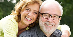 Elderly couple enjoying a smile outdoors